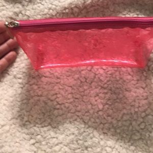 Small clear makeup bag.